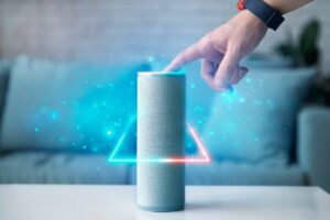 Person interacting with a smart speaker, emitting blue lights and geometric shapes, in a living room setting.