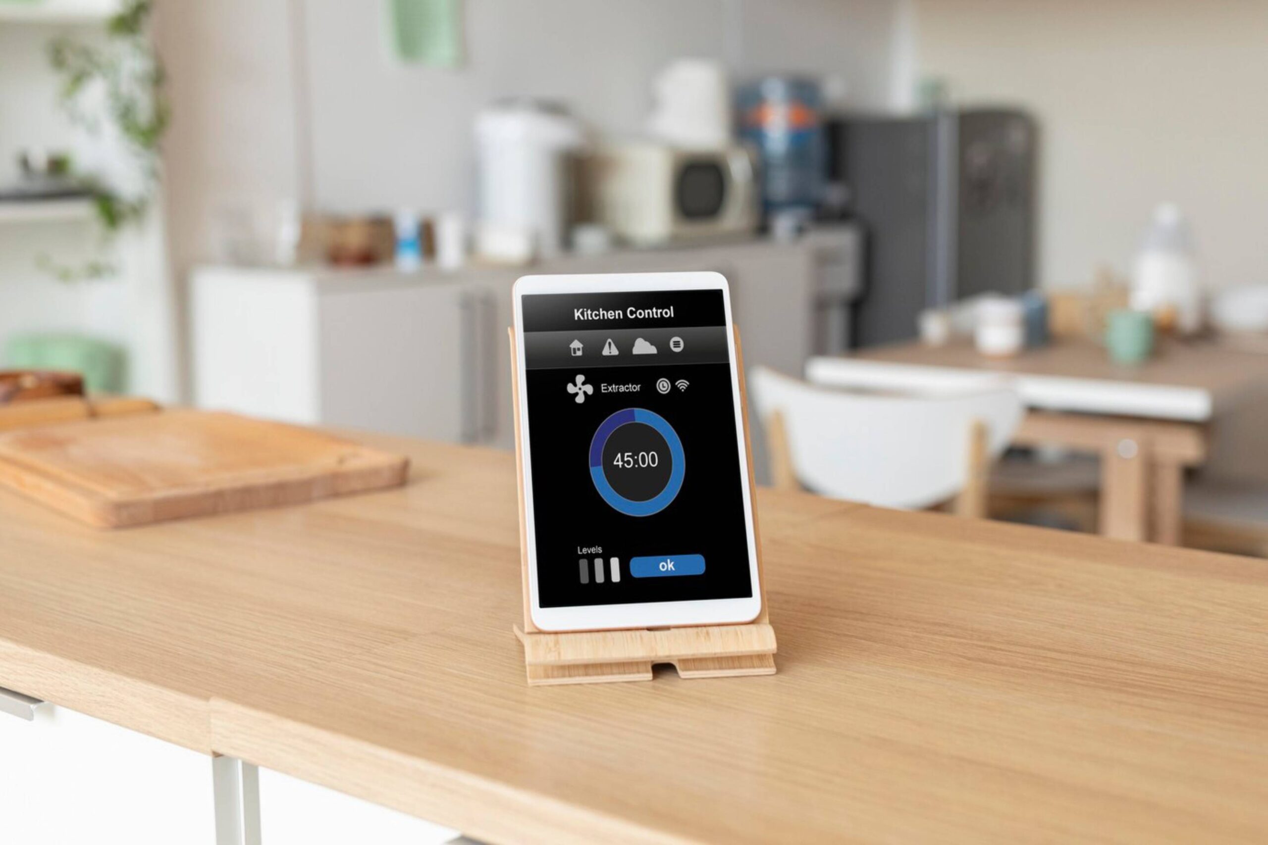 A modern kitchen featuring a digital tablet on a wooden stand displaying a kitchen control app. 