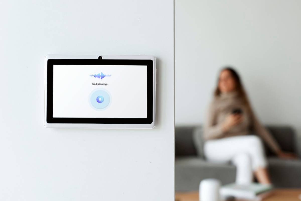 A woman interacts with a smart home assistant to manage her smart home devices efficiently.