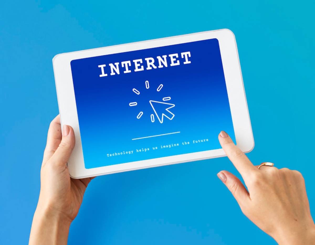 Hands holding a tablet displaying the word 
