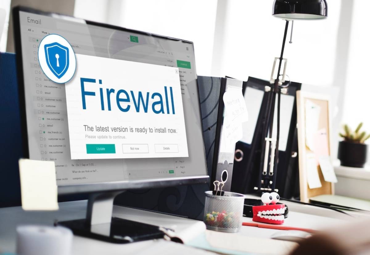  Computer screen displaying a firewall update notification in a modern office setting.