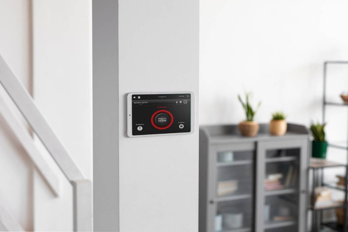 A smart home device is securely mounted on a white wall, showcasing modern technology in a home setting.